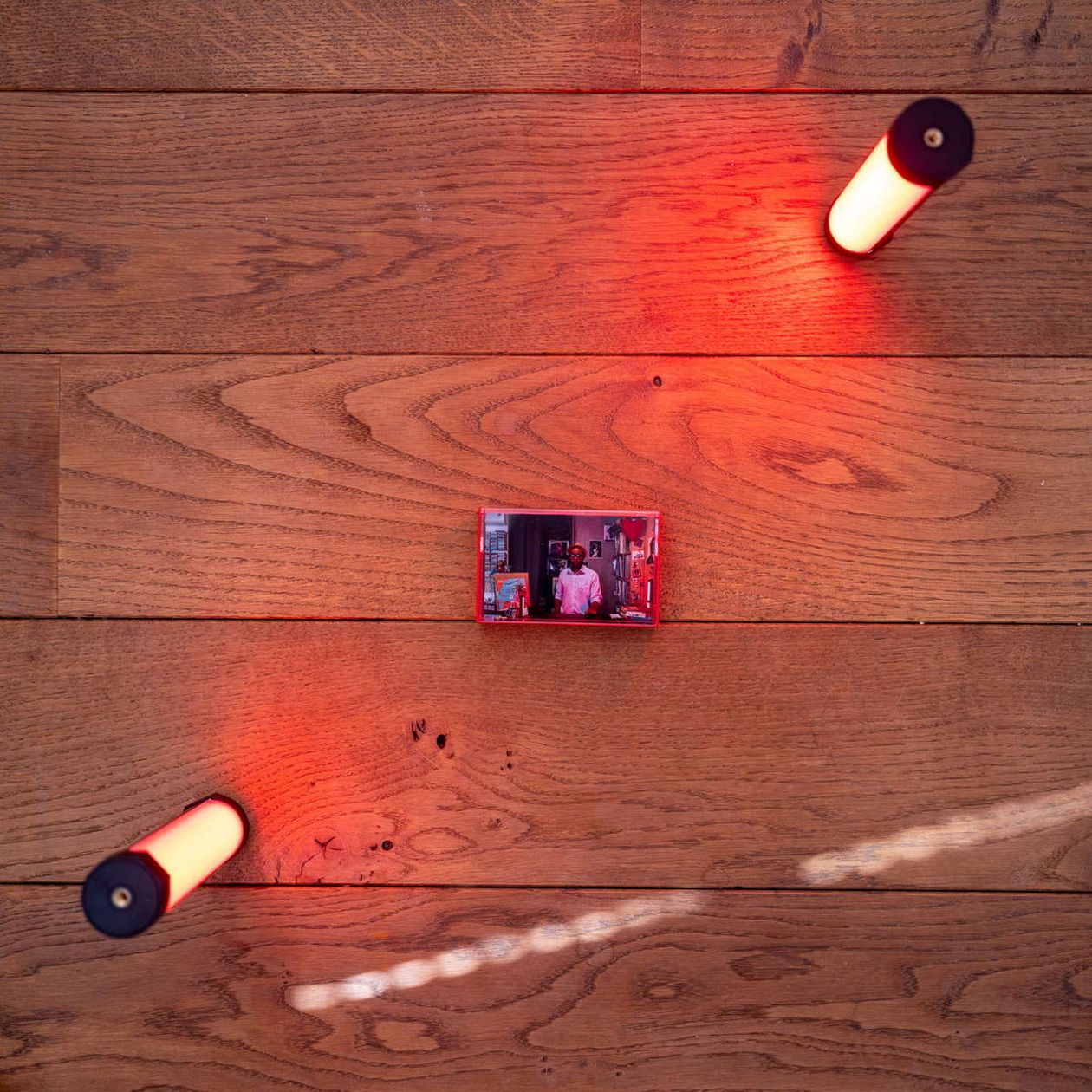 View from above of Luminous lamp and audio K7 on a wooden floor. 