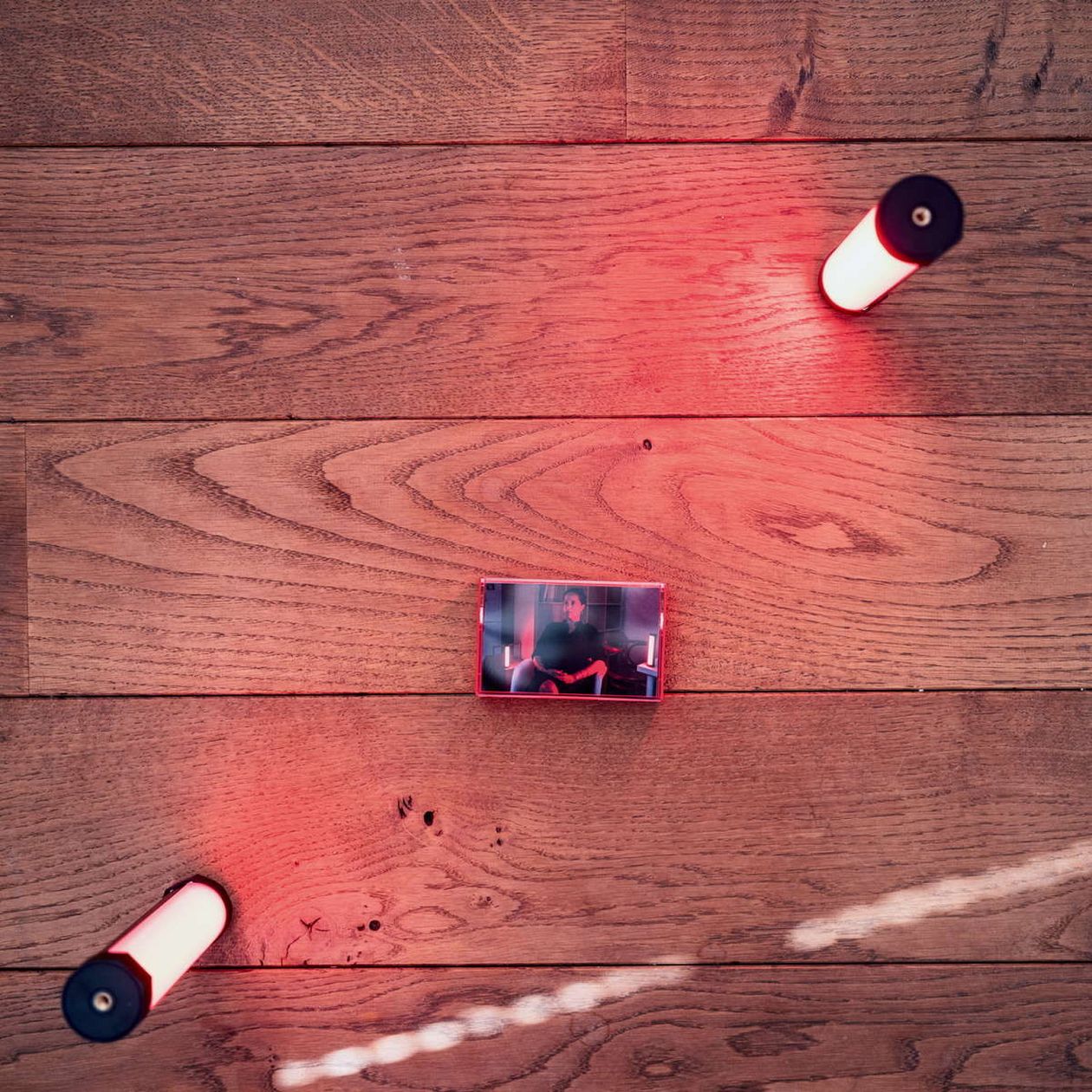 View from above of Luminous lamp and audio K7 on a wooden floor. 