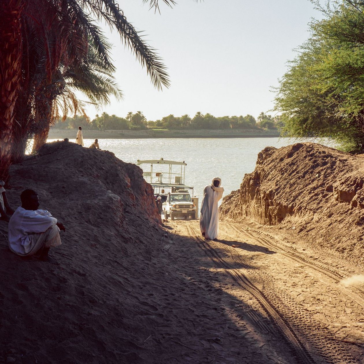 A young couple walks along the bank of the Nile river in Nubia, Sudan