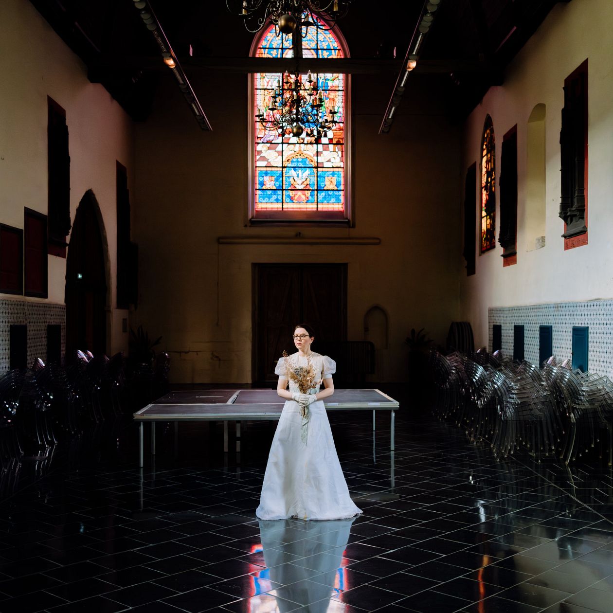 Beautiful bride in a white wedding dress posing in the interior of the church
