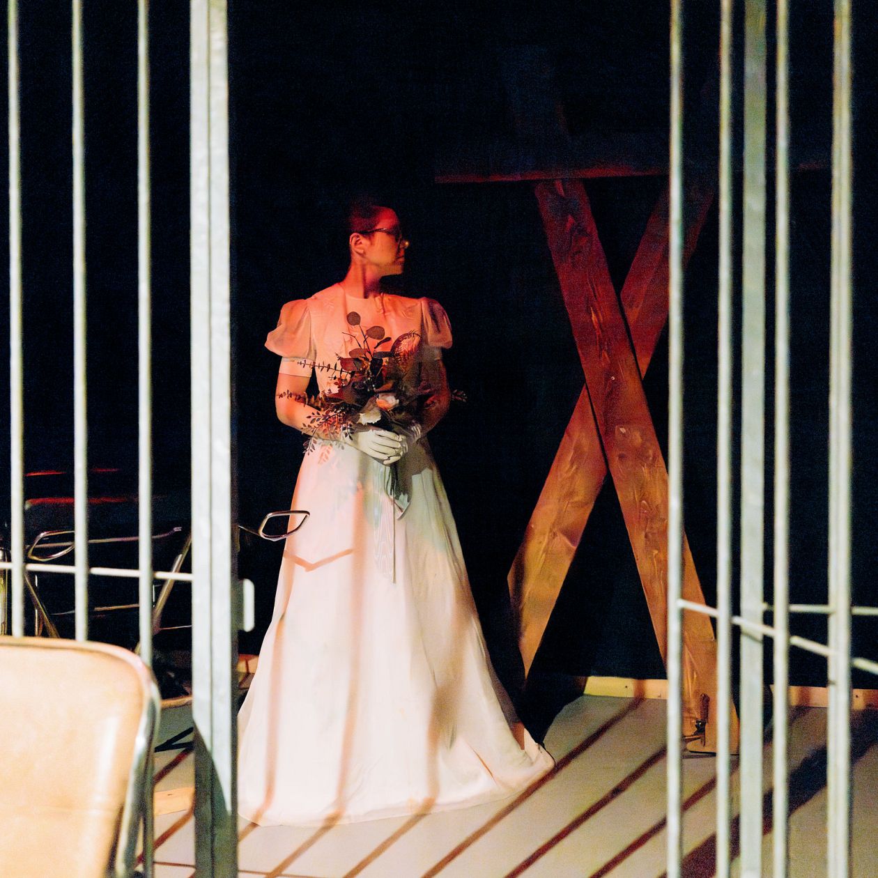 Beautiful young woman in a pink wedding dress in the interior of a BDSM club